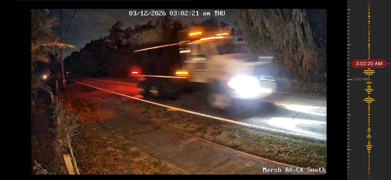 Dump truck captured at 3:02 AM on security camera with audio waveform