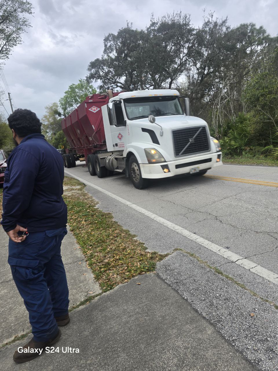 Volvo semi hauling dumpster over yellow center line on Marsh Road in DeLand Highlands